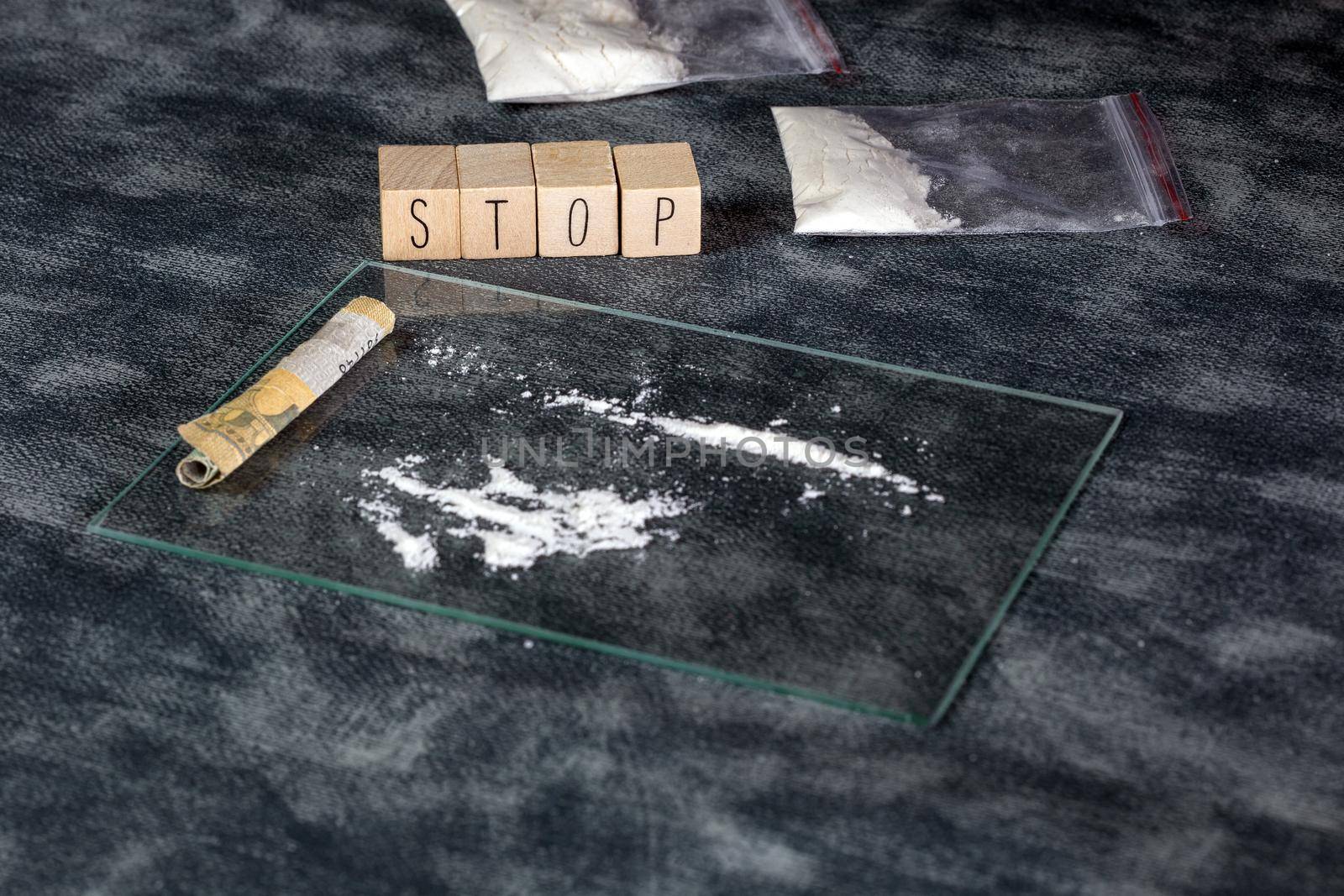 Drugs addiction, white powder line,cocaine,speed or other drugs and syringe with Heroin and the text STOP. Junk,Addiction,drug concept background help