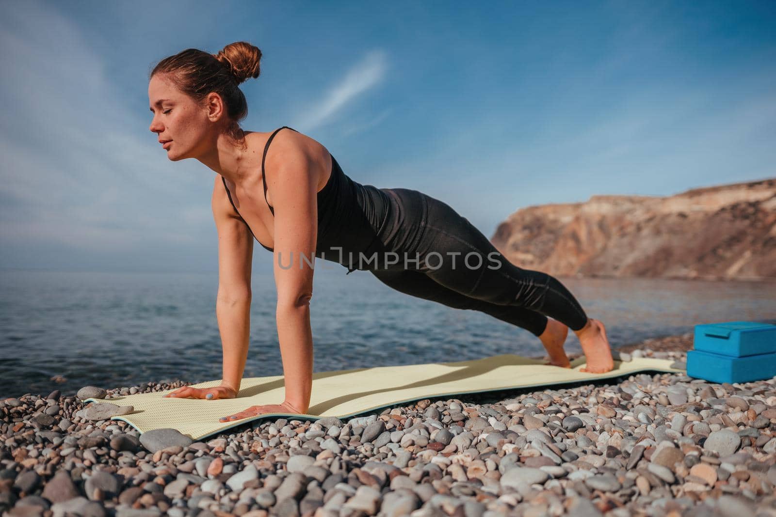 Group of young womans fitness instructor in Sportswear Leggings and Tops, stretching in the gym before pilates, on a yoga mat near the large window on a sunny day, female fitness yoga routine concept.