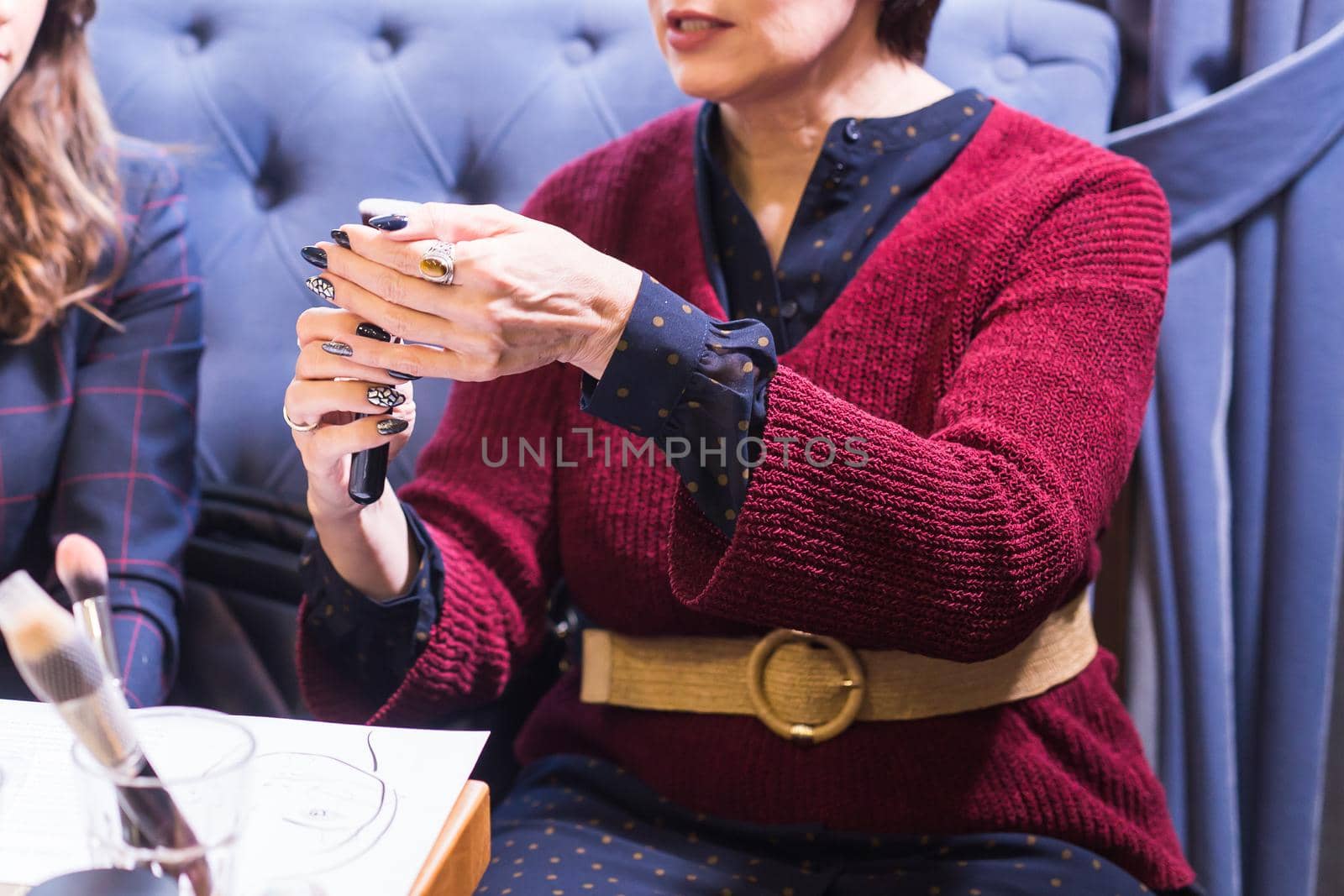 Close up view of woman's hand holding make-up brush.