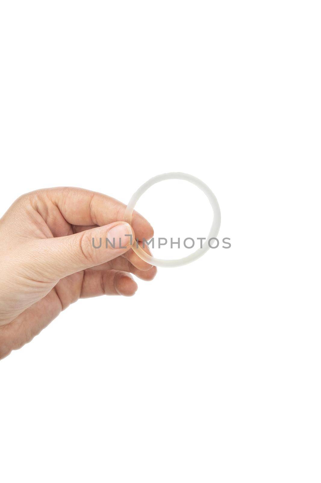 Birth control ,hormone, contraception ring in a womans hand isolated on white background, vaginal ring for contraceptive use with copy space closeup