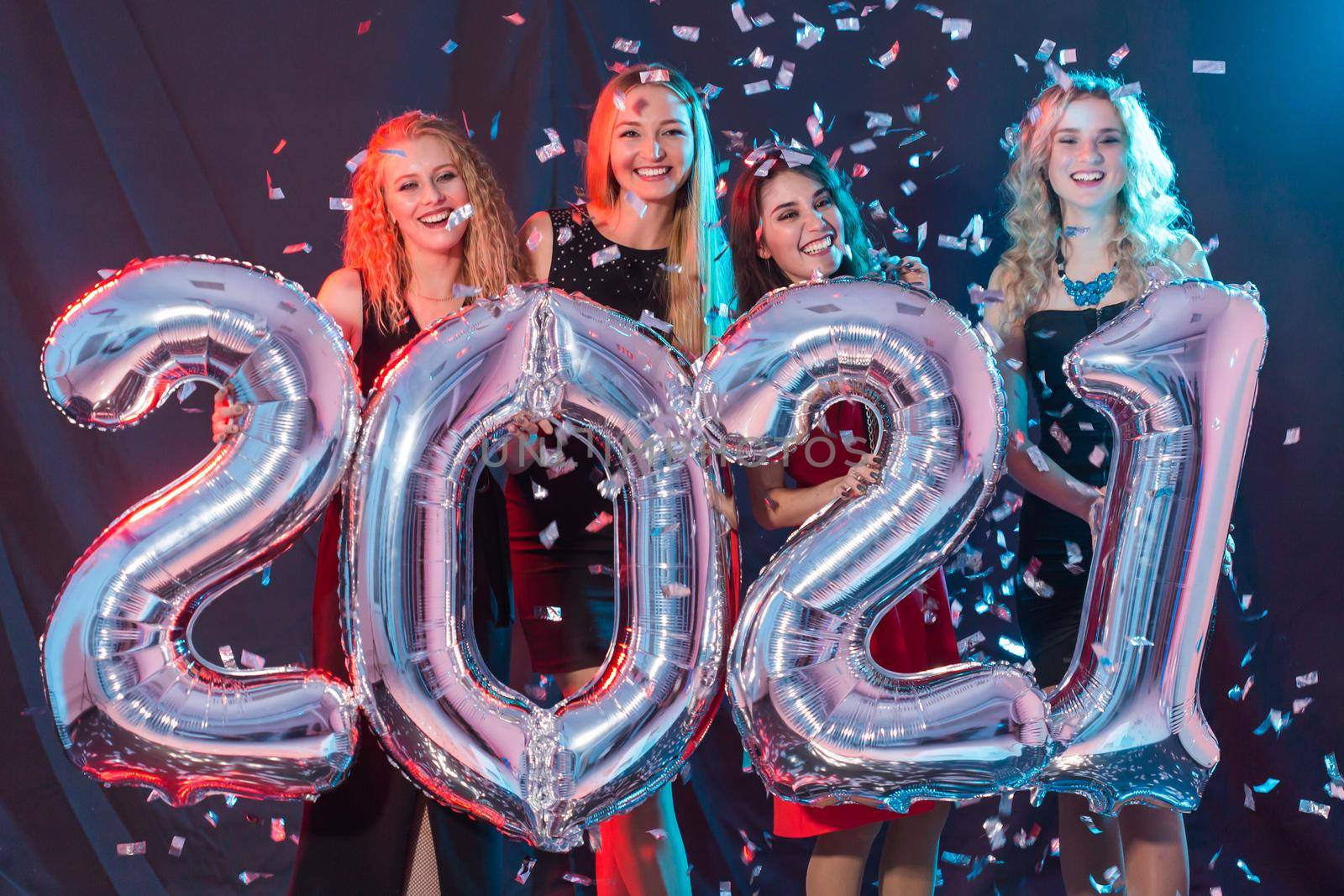 Party, people and new year holidays concept - cheerful young women celebrating new years eve 2021 by Satura86