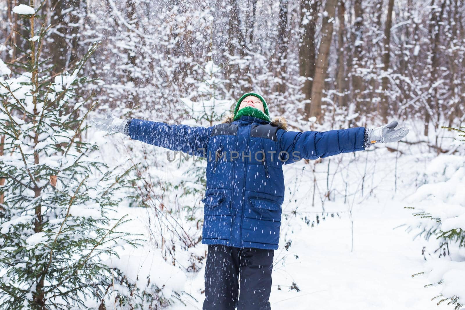 Happy boy throwing snow. Child, season and winter concept. by Satura86