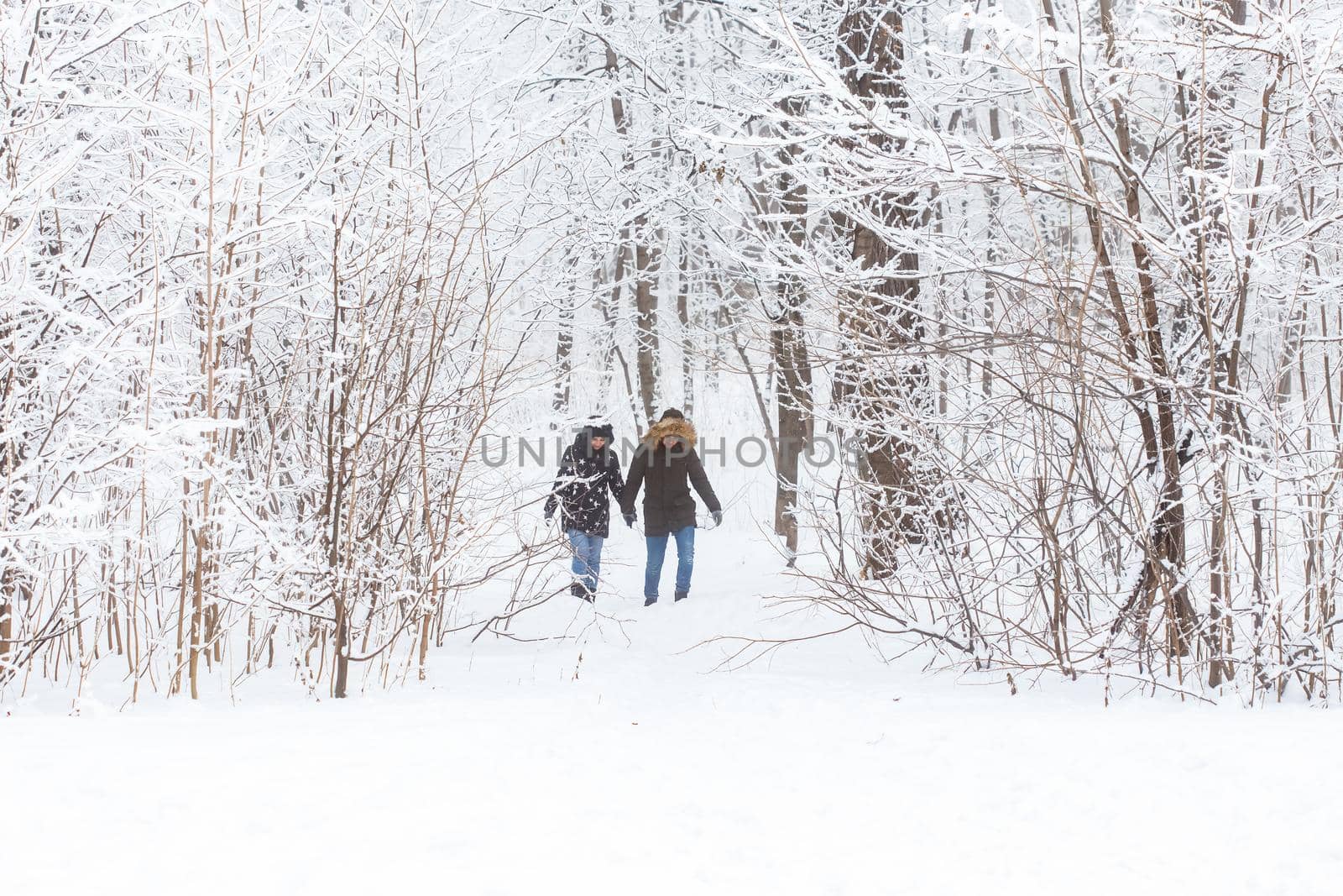 Happy loving couple having fun outdoors in snow park. Winter vacation by Satura86