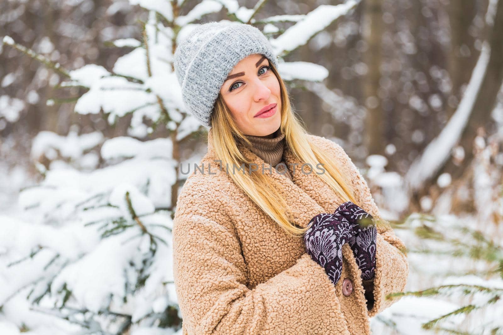 Attractive young woman in winter time outdoor. Snow, holidays and season.