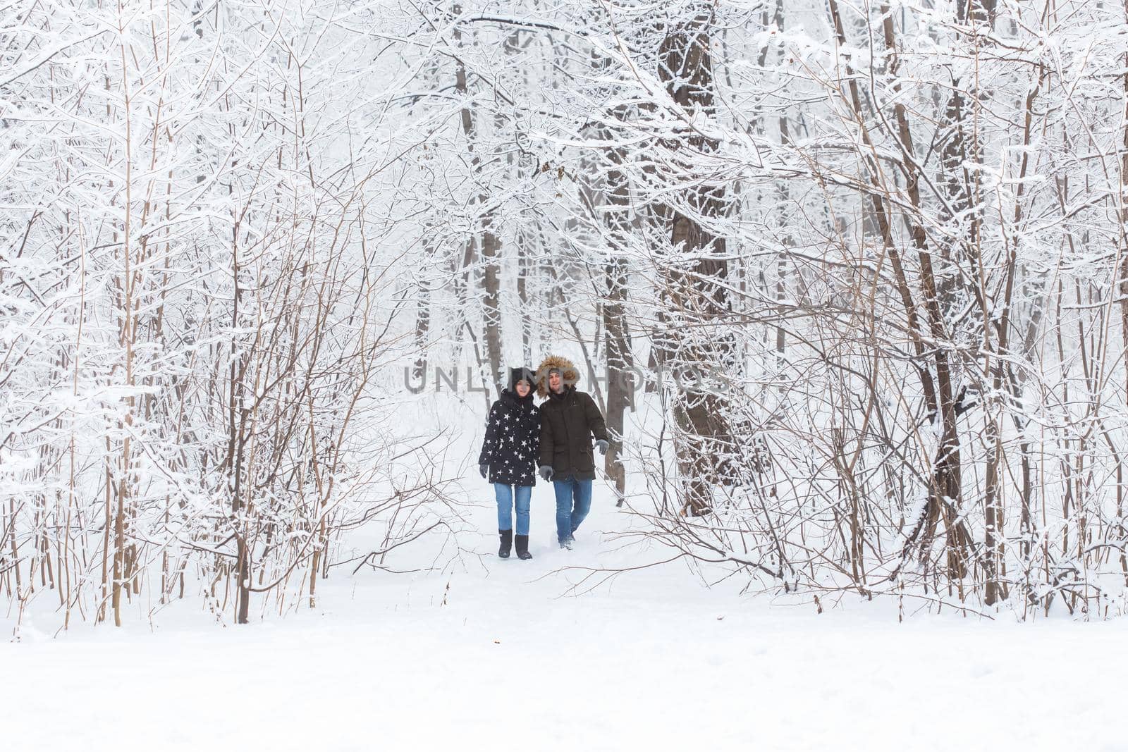 Happy loving couple having fun outdoors in snow park. Winter vacation by Satura86