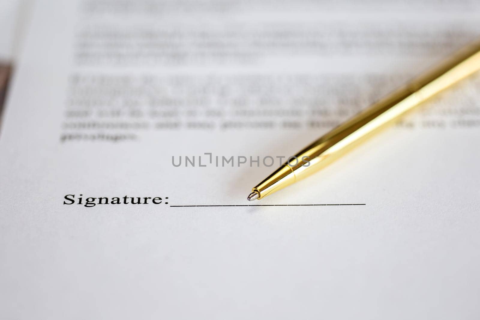 Signing a contract with signature with gold pen macro close-up, businessman,contract,deal,concept background by Annebel146