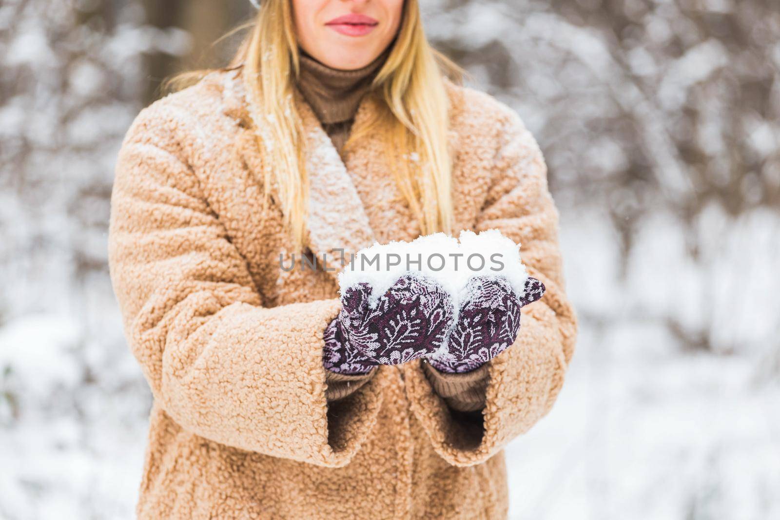 Close up of woman holding snow in hands, winter concept. by Satura86