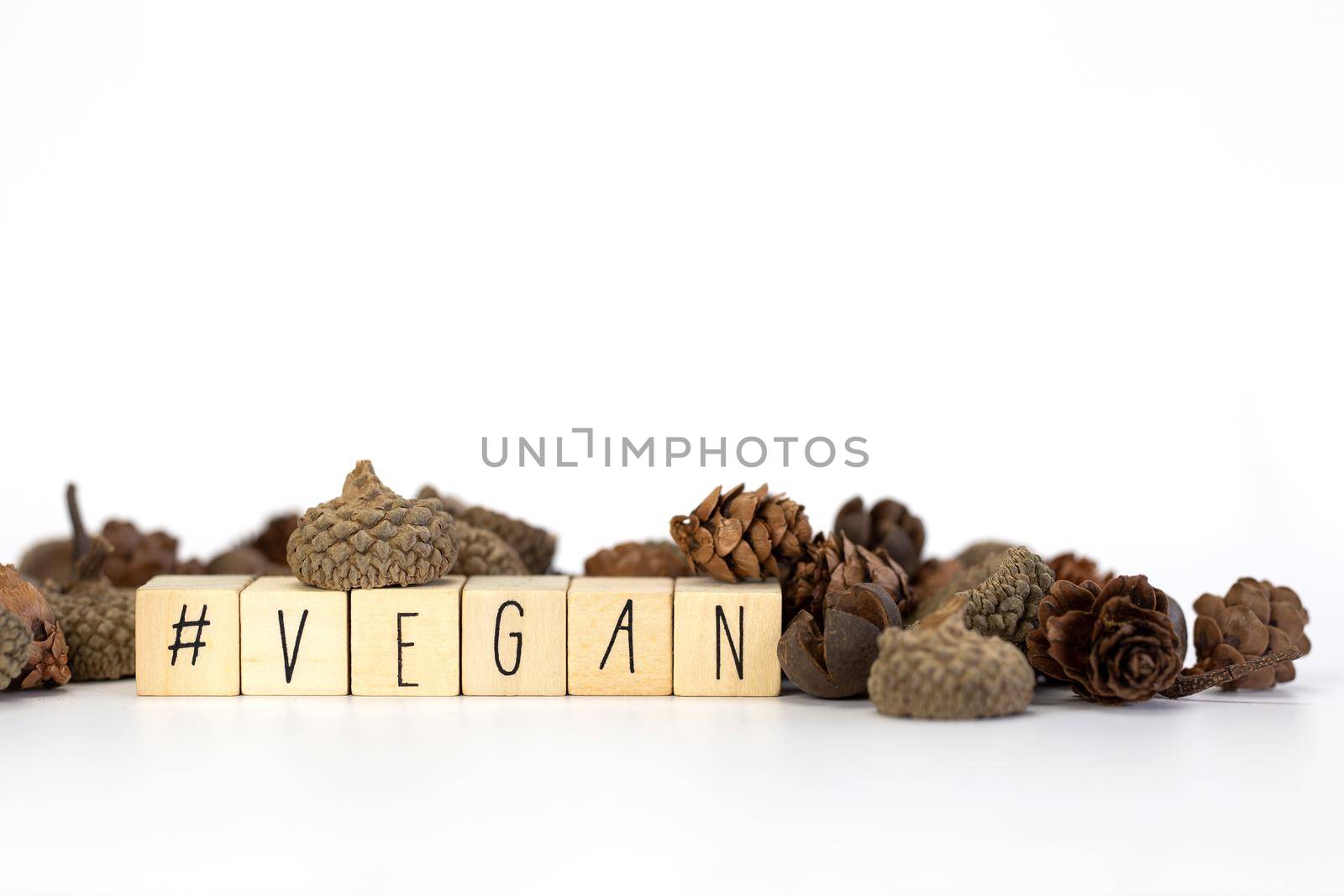 Vegan and hashtag written with wooden cubes and nature decoration isolated on white background with copy space, vegan,vegetarian,health concept background modern design natural style by Annebel146