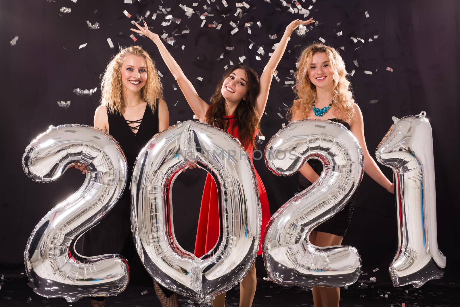 Party, people and new year holidays concept - cheerful young women celebrating new years eve 2021 by Satura86