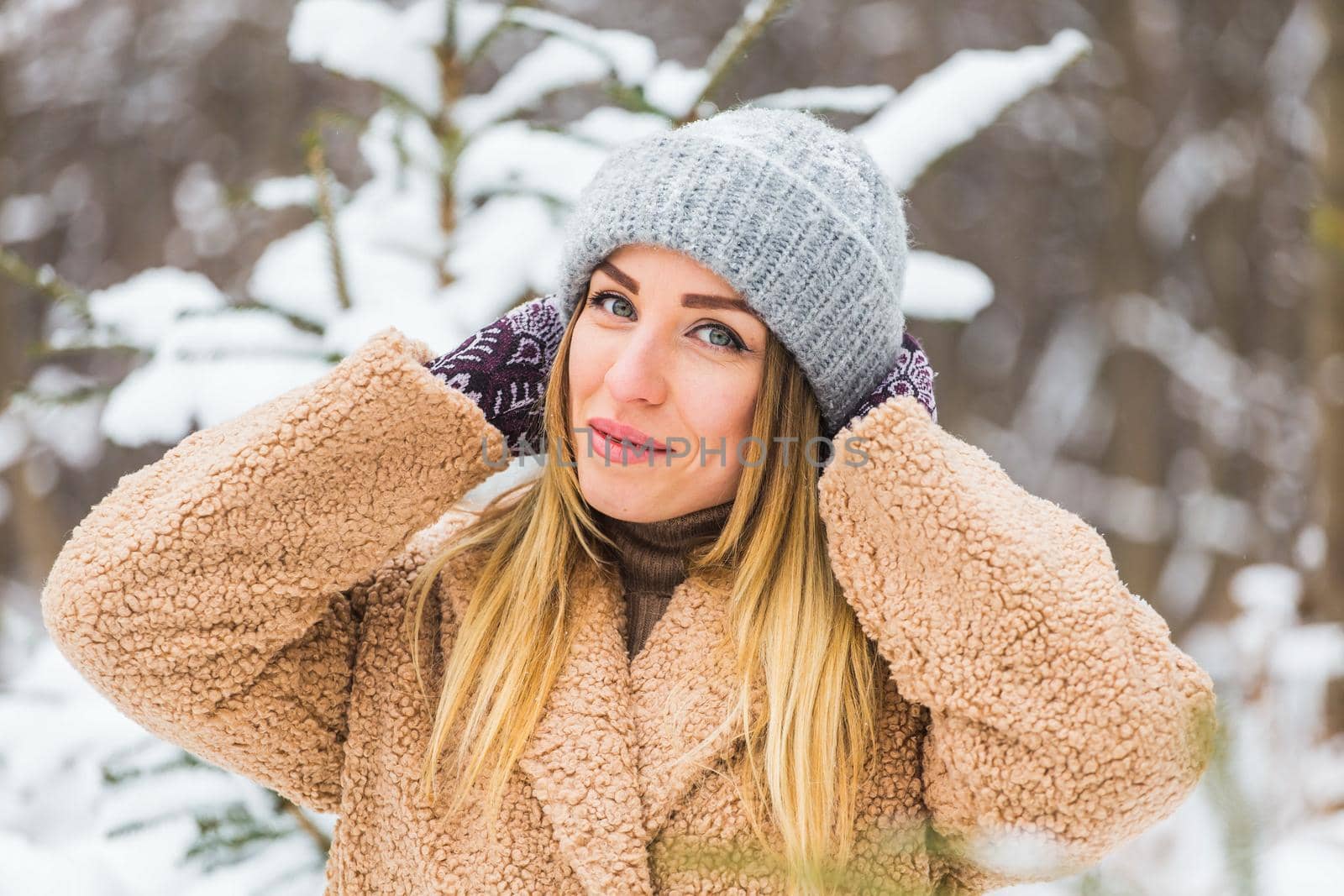 Attractive young woman in winter time outdoor. Snow, holidays and season.