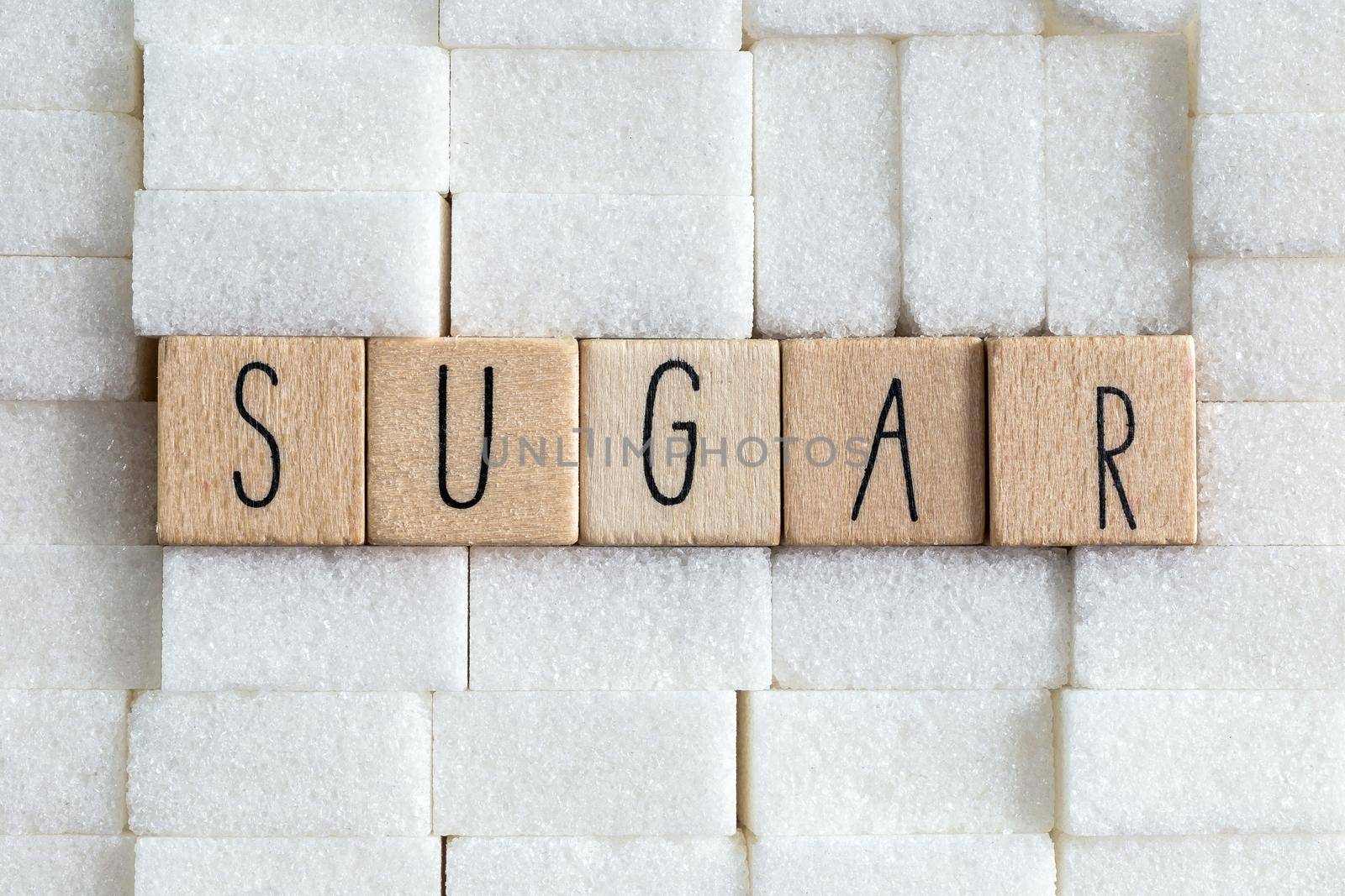 Sugar cubes wall with the text Sugar on brown natural background texture, Health,diabetes,medical,sugar,sweet.junk food concept copy space