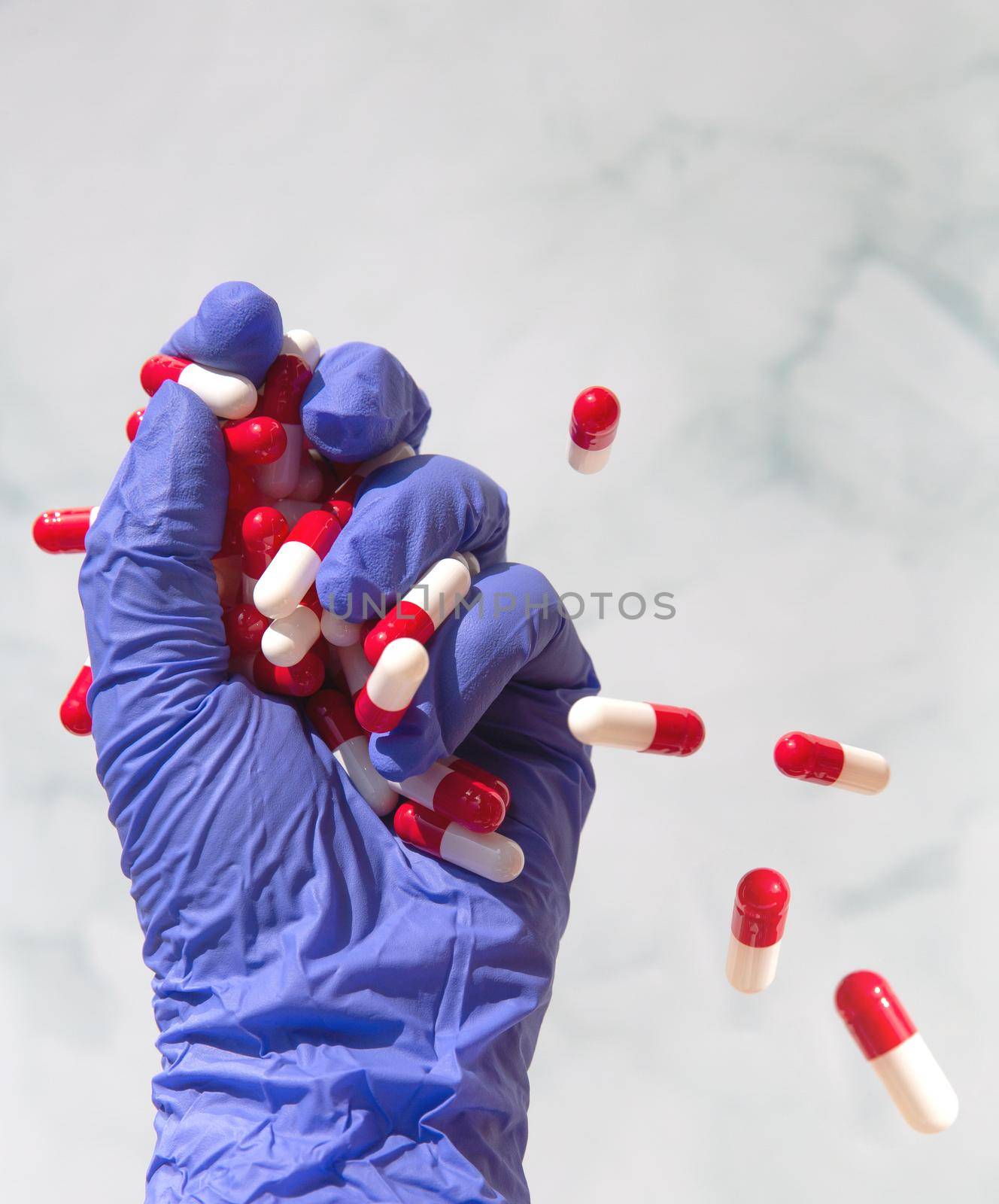 A hand grabbing hand full of medicines, Capsules for Vitamines,drugs,medication. Health,business concept background copy space