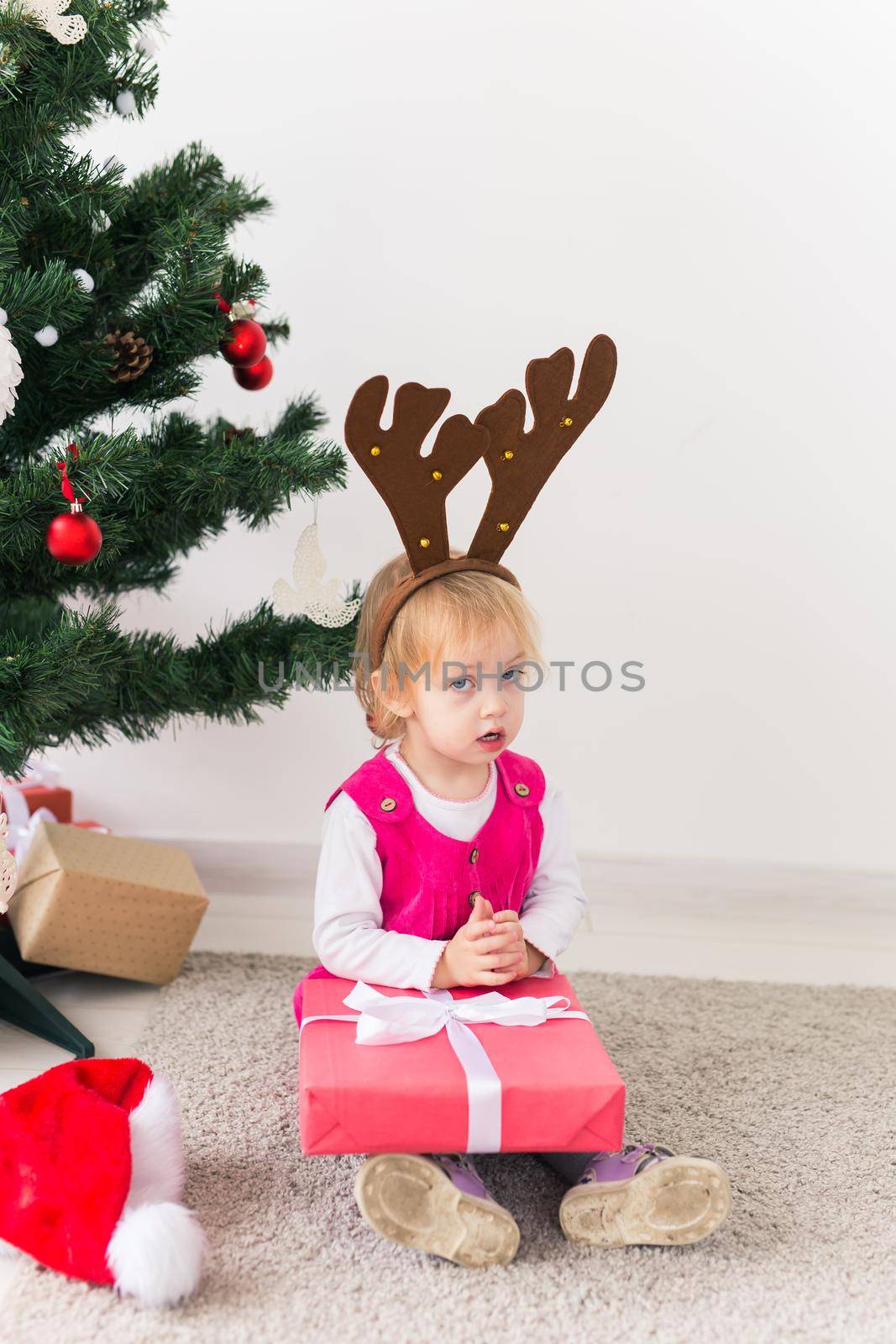 Baby holding Christmas gift. Winter holidays concept. by Satura86