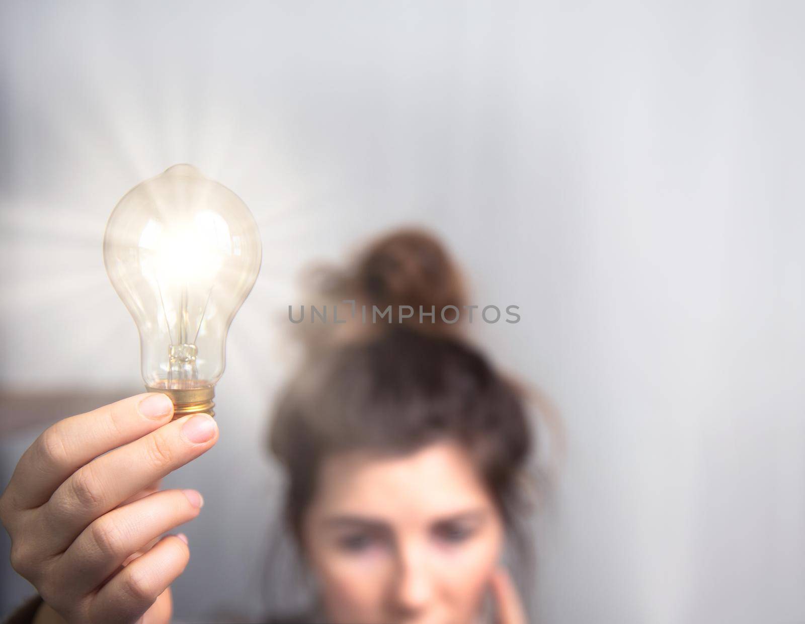 Young business woman brainstorming, creating ideas,education,learning concept with shining light bulb and copy space space for text