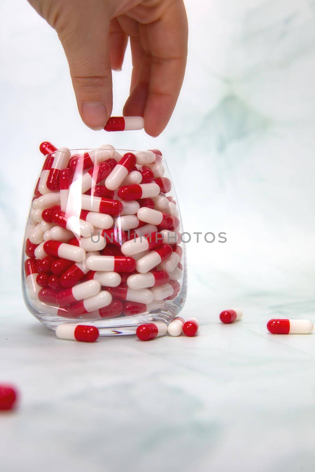 A hand grabbing hand full of medicines, Capsules for Vitamines,drugs,medication. Health,business concept background copy space