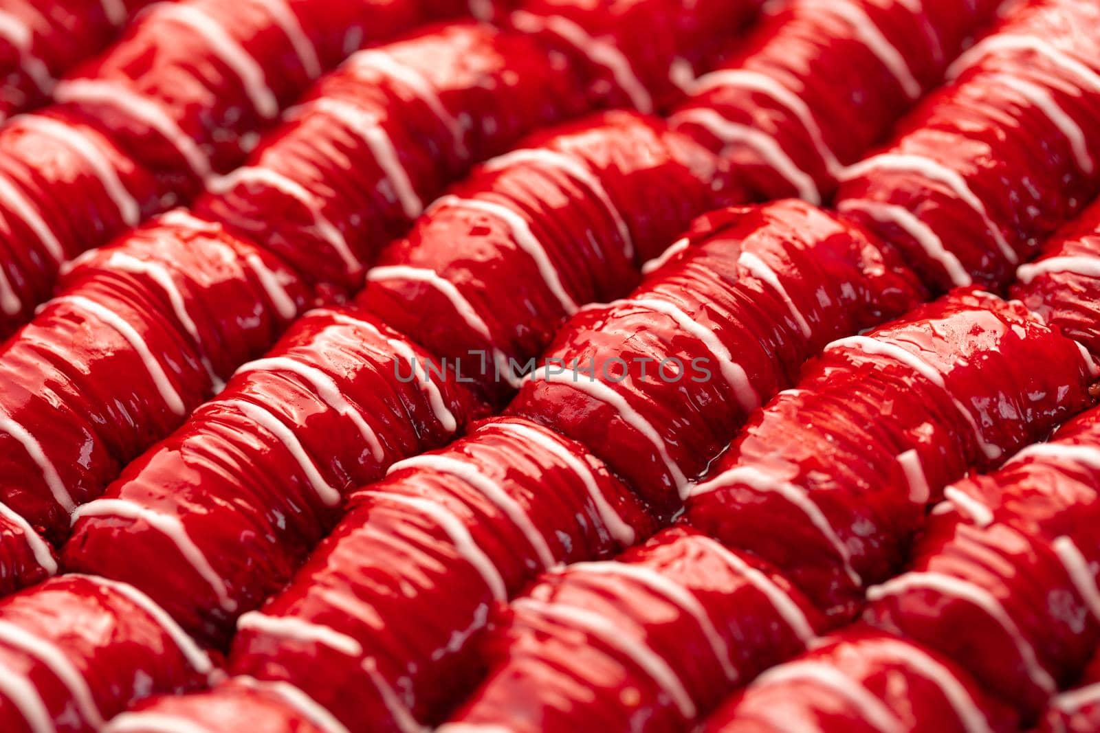 Red colored Turkish dessert baklava placed in rows, for background