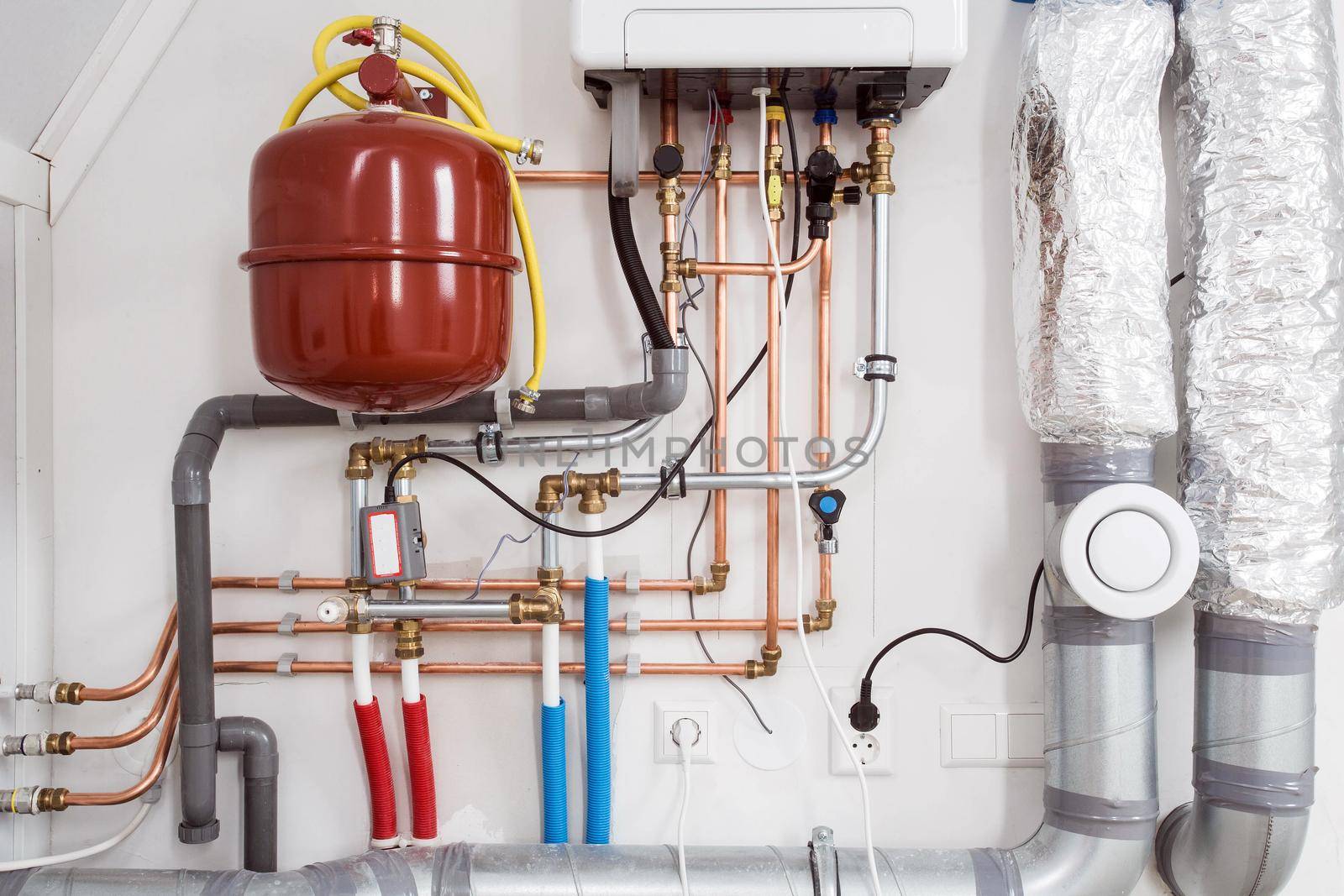 Heating installation and central boiler heating system on wall in house close-up modern