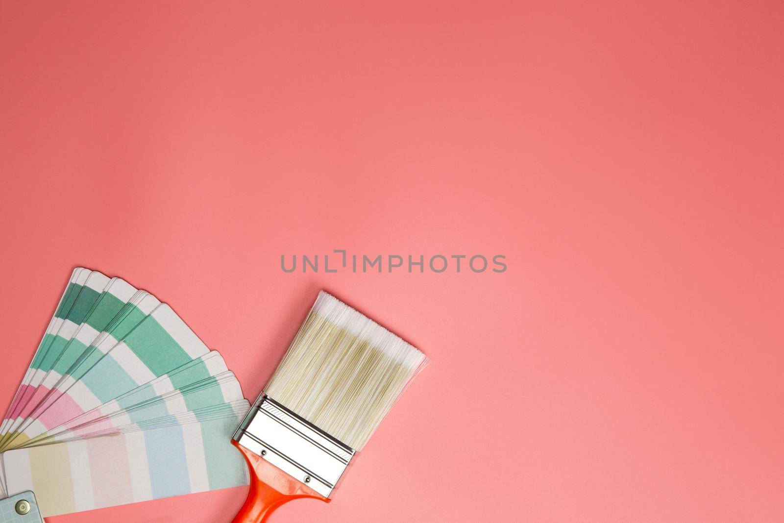Paintbrush with palette for painting sample with pastel colors on pink background top view, Flat lay,copy space, home,concept background space for text