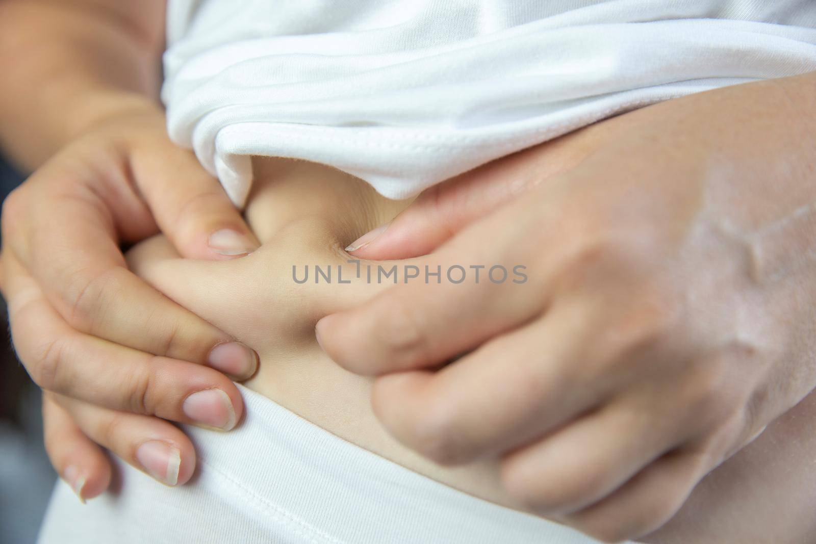 Young female wearing white underwear checking and squeeze her belly fat condition stomach closeup