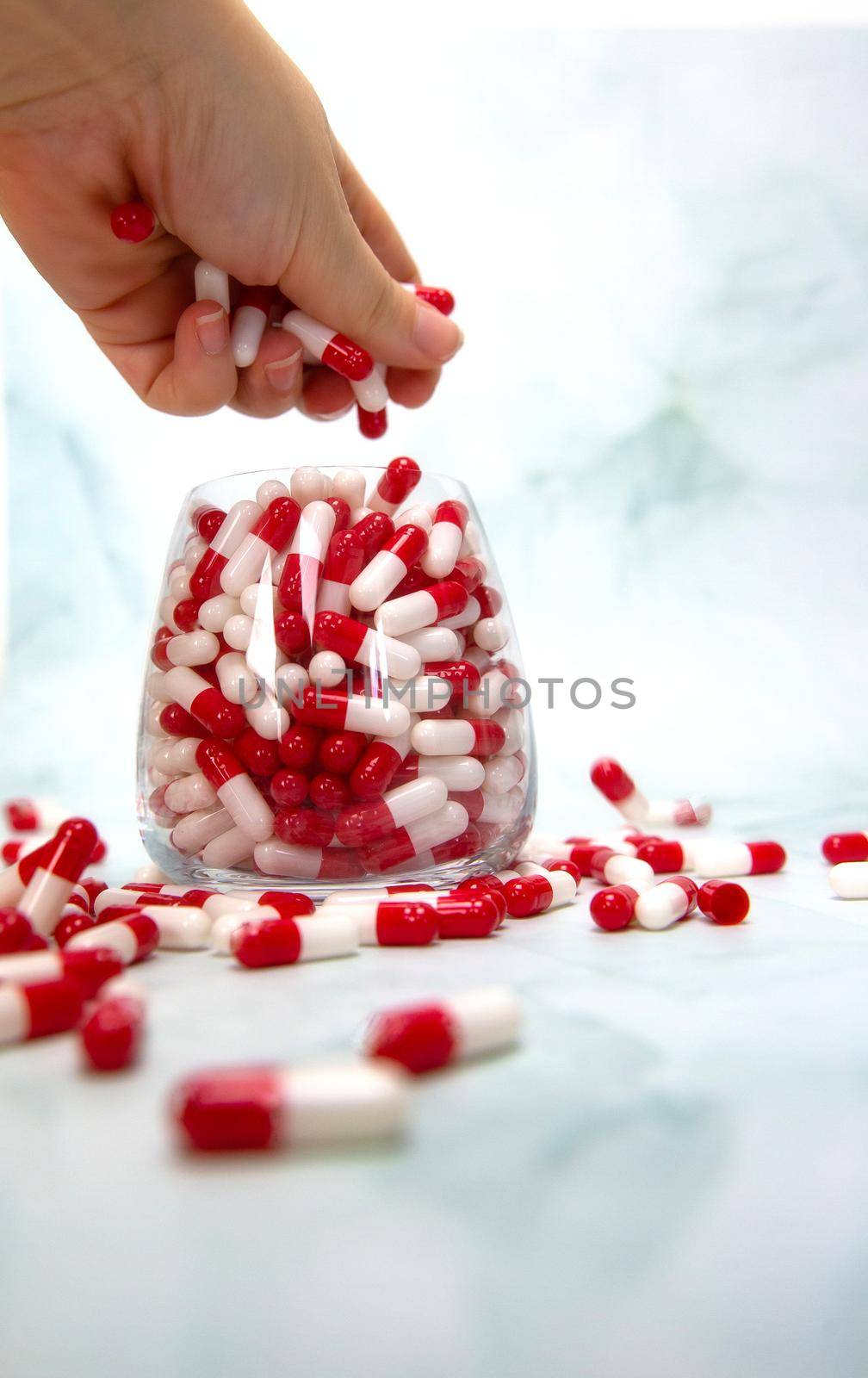 A hand grabbing hand full of medicines, Capsules for Vitamines,drugs,medication. Health,business concept background copy space