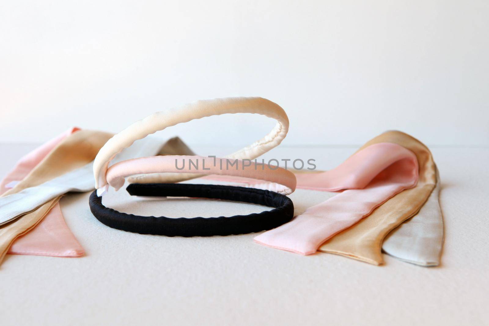 yellow and pink silk ribbons and Scrunchy isolated on white. Flat lay Hairdressing tools and accessoriesas Color Hair Scrunchies, Elastic Hair Bands, Orbital Hair ring or hair hoop