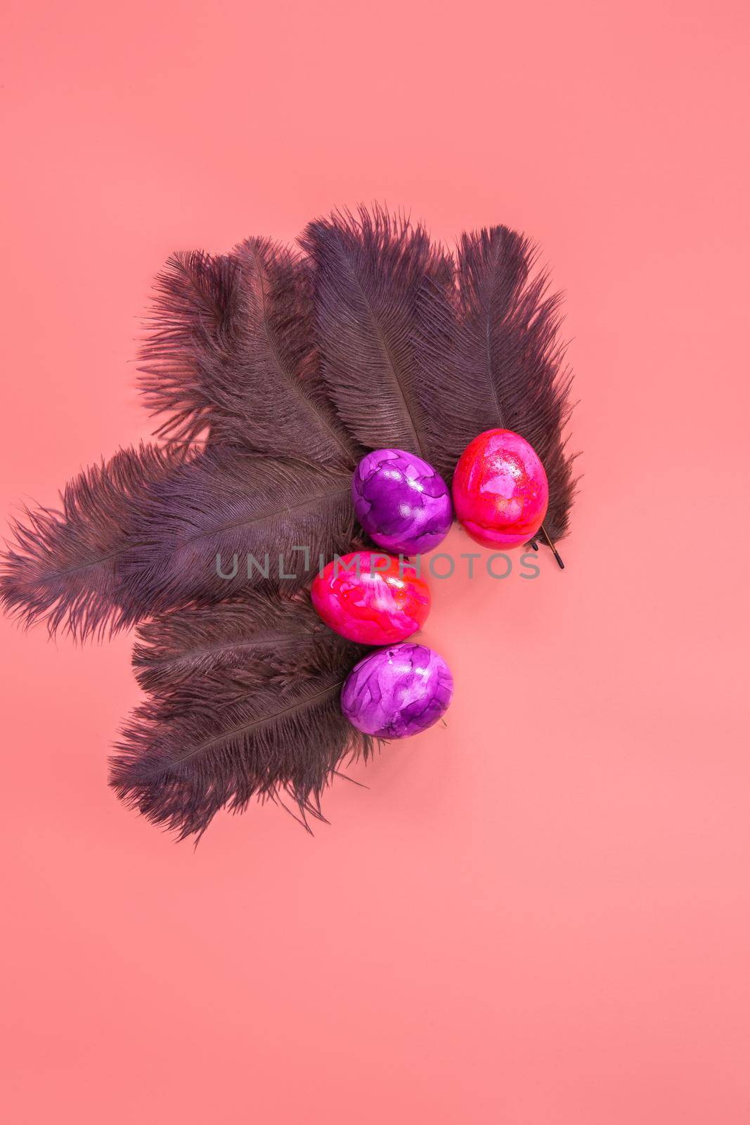 Happy Easter background Easter eggs and feather on pastel pink background, top view, flat lay, Easter holiday concept. copy space space for text