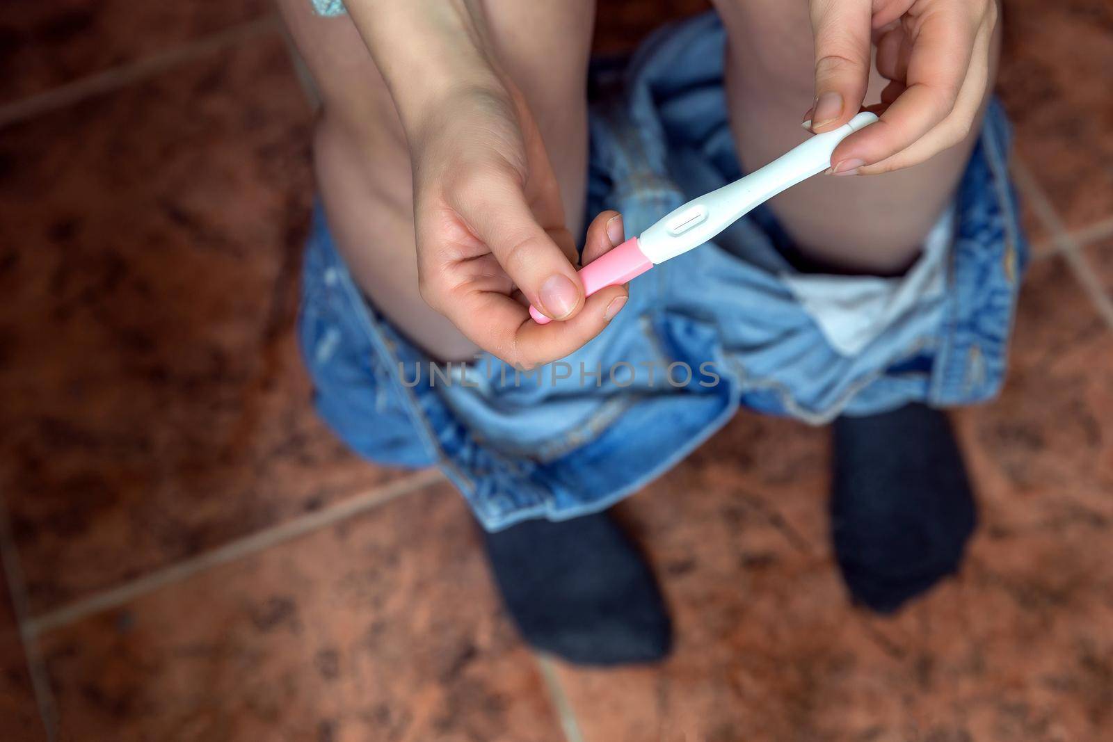 Young woman checking results of a pregnancy test in bathroom close-up, new life,family,mother,baby concept modern design