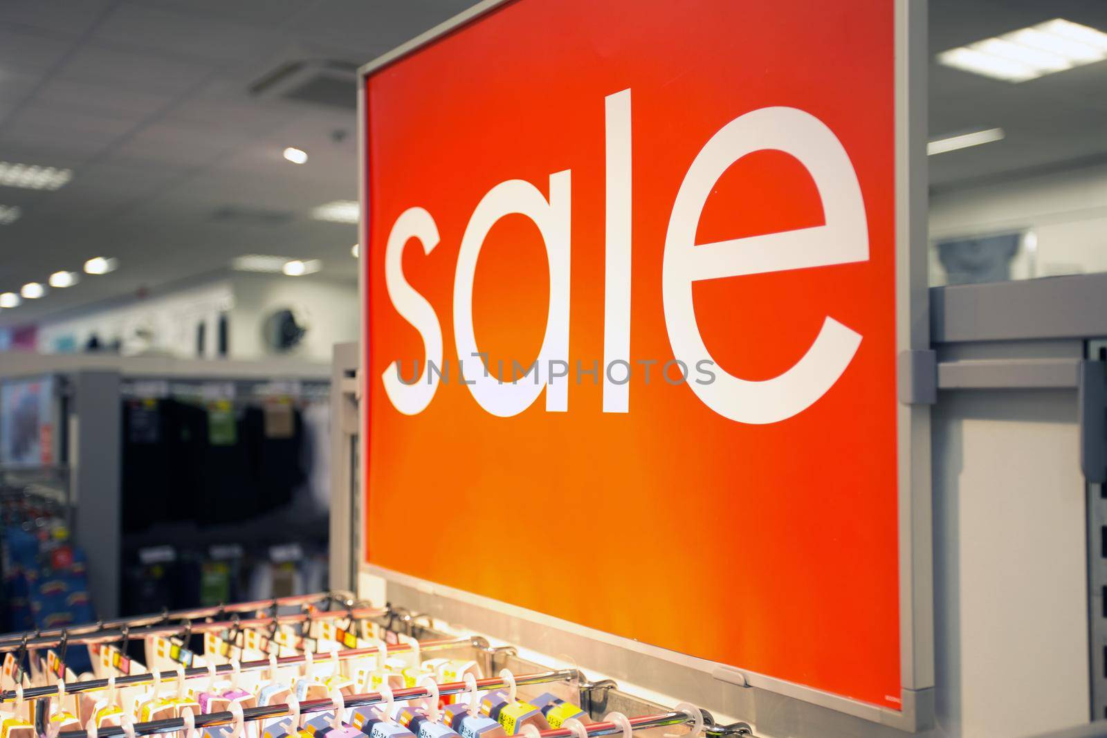 Sale sign text in clothing store marketplace, shopping in the mall, sale,business concept background close up