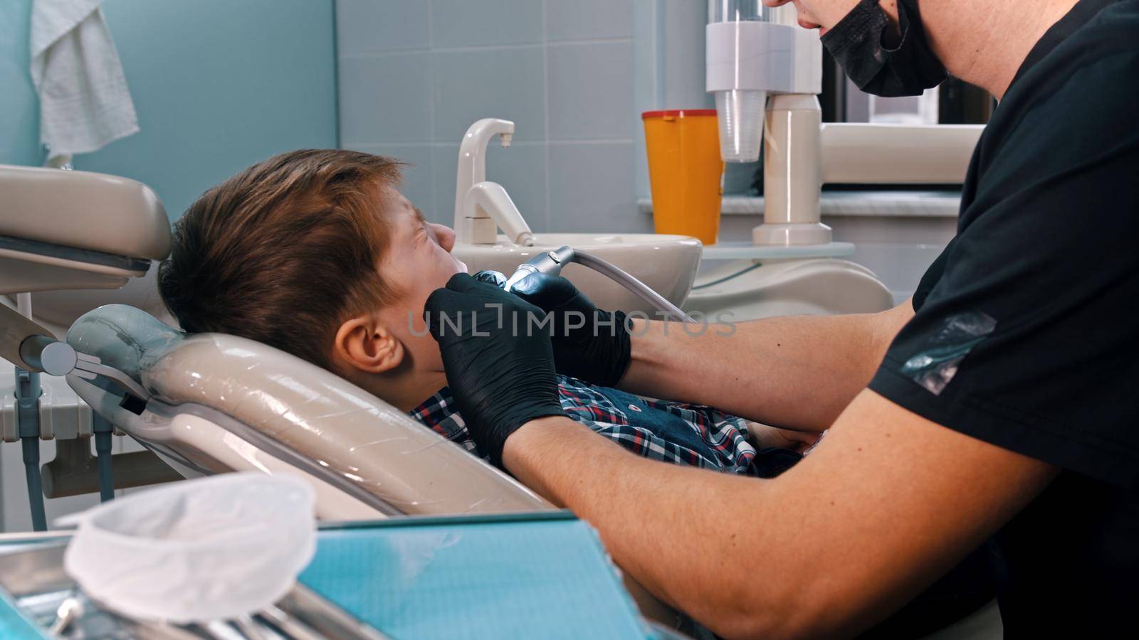 A little boy getting his teeth done in the modern dentistry by Studia72