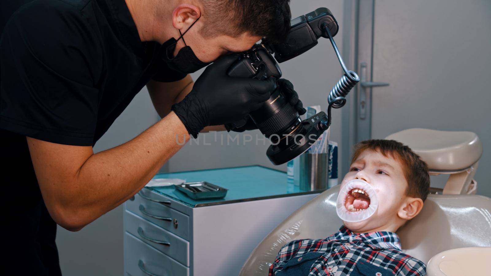A boy having a treatment in the dentistry - the boy with opened mouth by Studia72