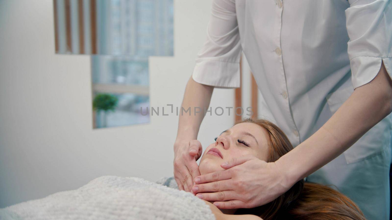 Massage - a masseuse is massaging her clients neck by Studia72