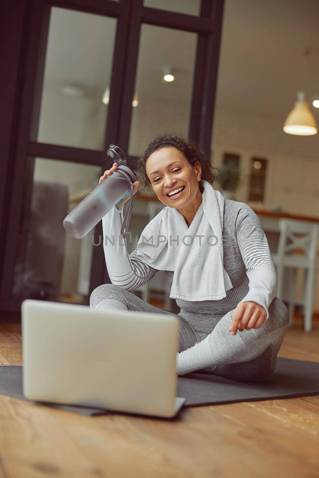 Happy young woman doing training with laptop indoors by Yaroslav_astakhov