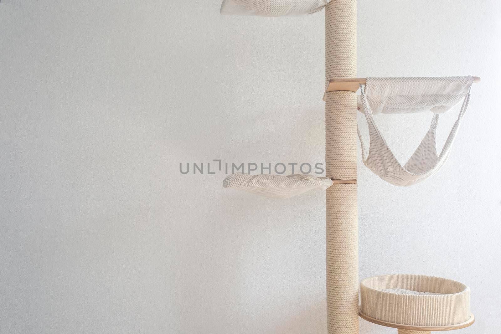 Cat scratching post wall mounted in modern room for pet on white wall, stylish decoration for cat owner by Annebel146