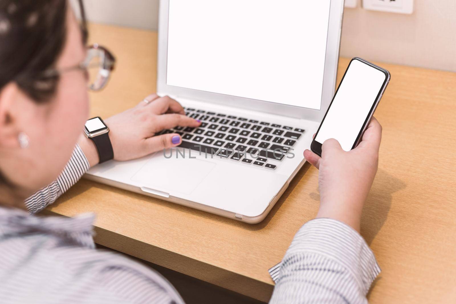 set of modern computer devices - laptop, watch and phone close up