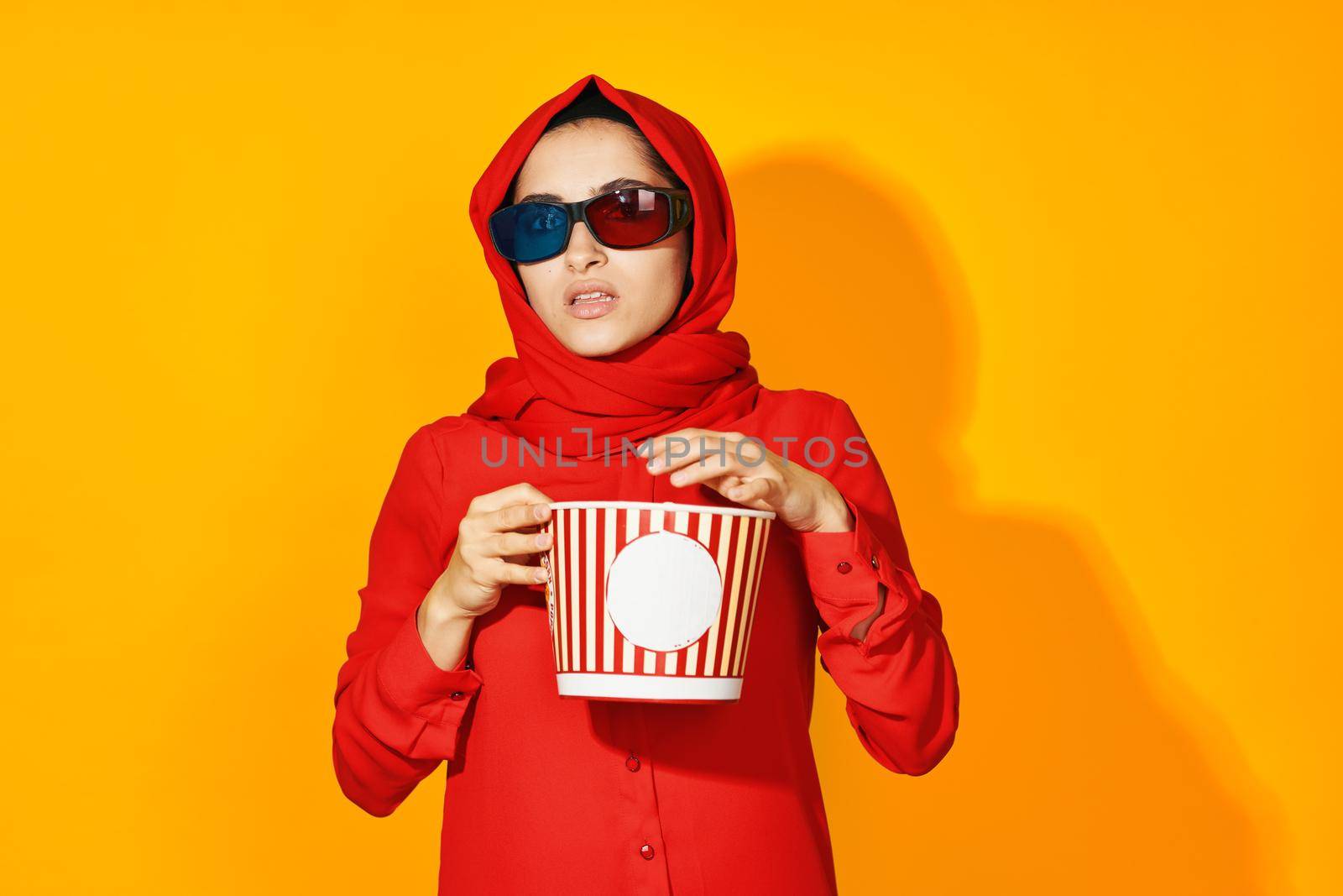 woman in red hijab popcorn entertainment cinema ethnicity model. High quality photo