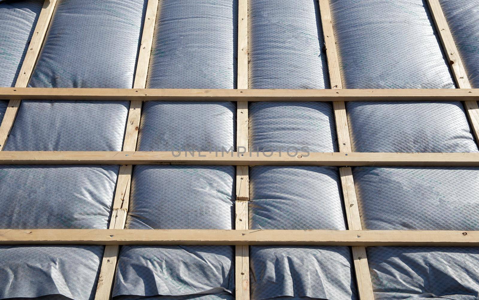 New roof coverings with insulation, isolation tiled roof, house renovation close-up background of insulation work in progress