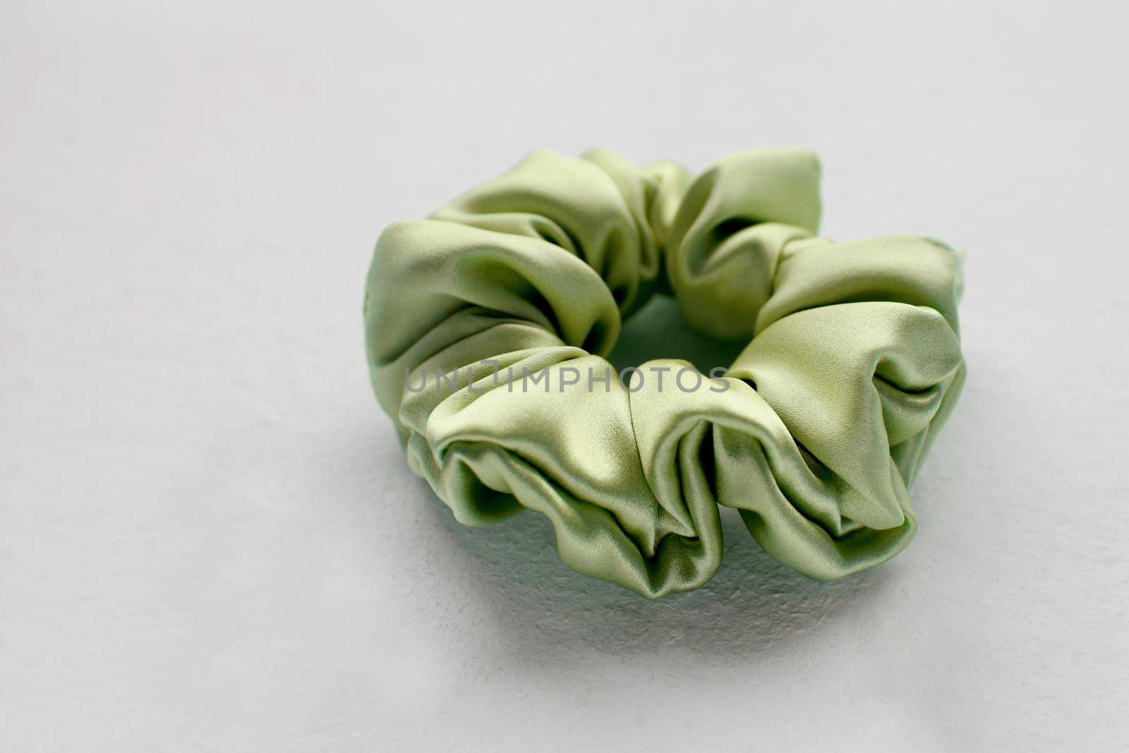 green silk Scrunchy isolated on white background. Flat lay Hairdressing tool of Colorful Elastic Hair Band, Bobble Sports Scrunchie Hairband