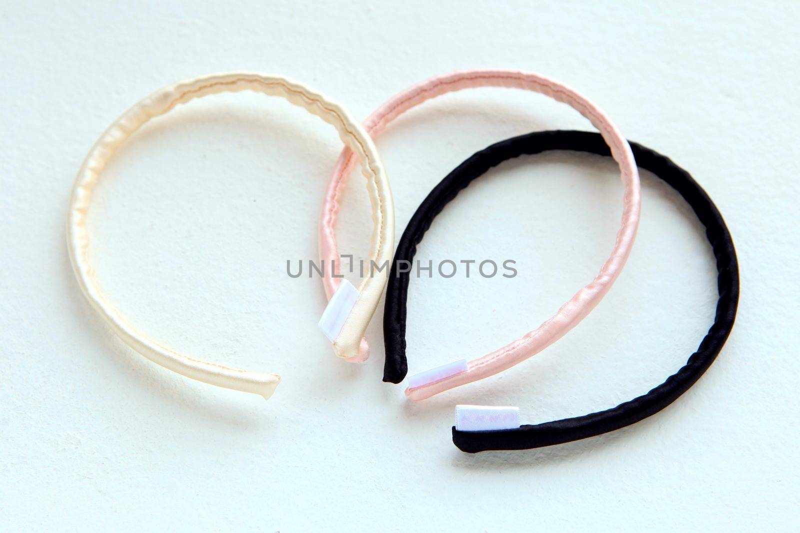 yellow and pink silk ribbons and Scrunchy isolated on white. Flat lay Hairdressing tools and accessoriesas Color Hair Scrunchies, Elastic Hair Bands, Orbital Hair ring or hair hoop