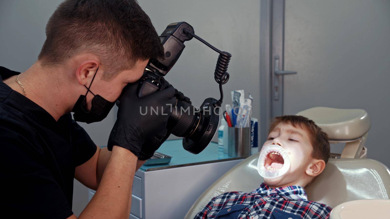 A little boy having a treatment in the dentistry - the boy with opened mouth by Studia72