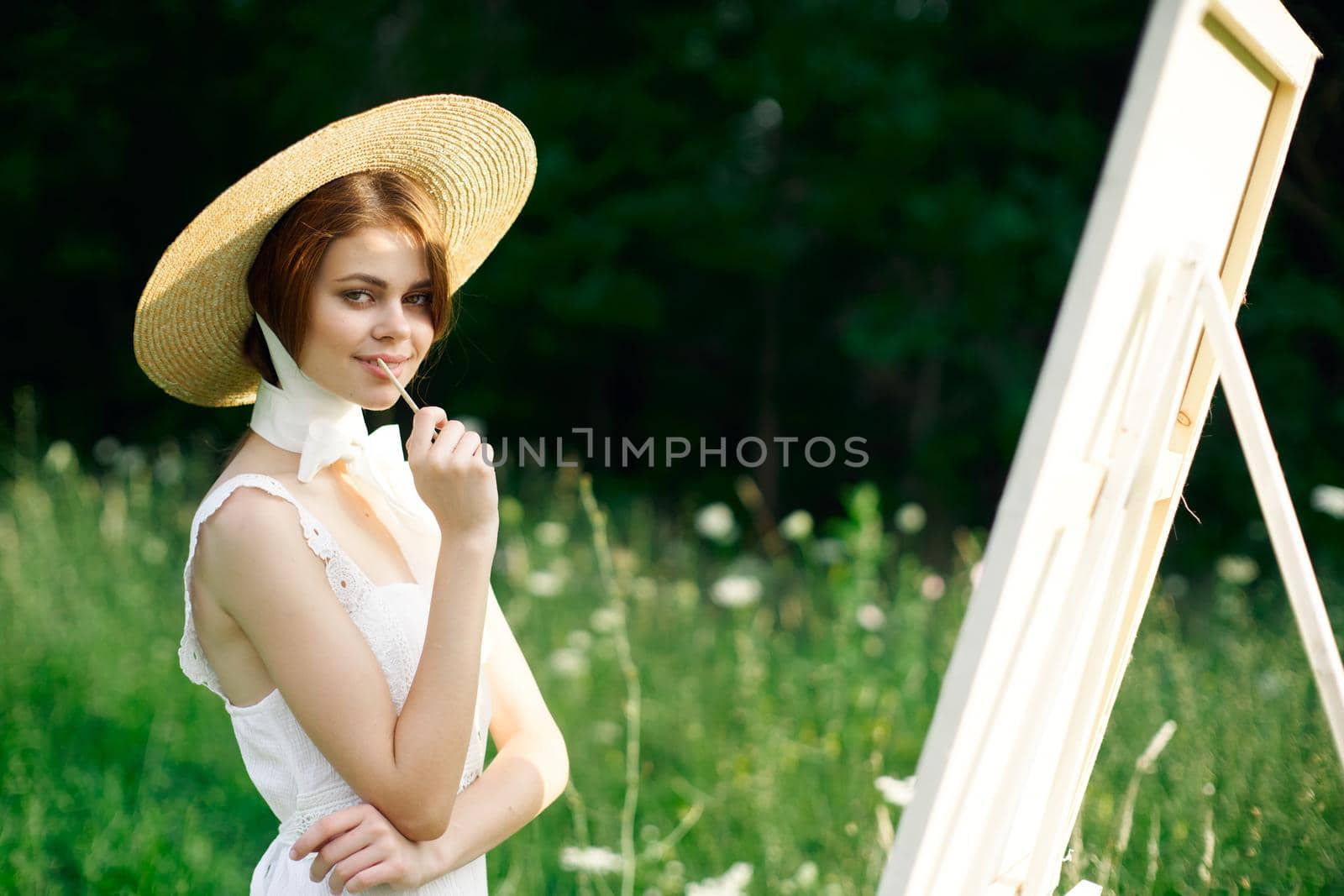 Woman in white dress artist hobby nature landscape. High quality photo