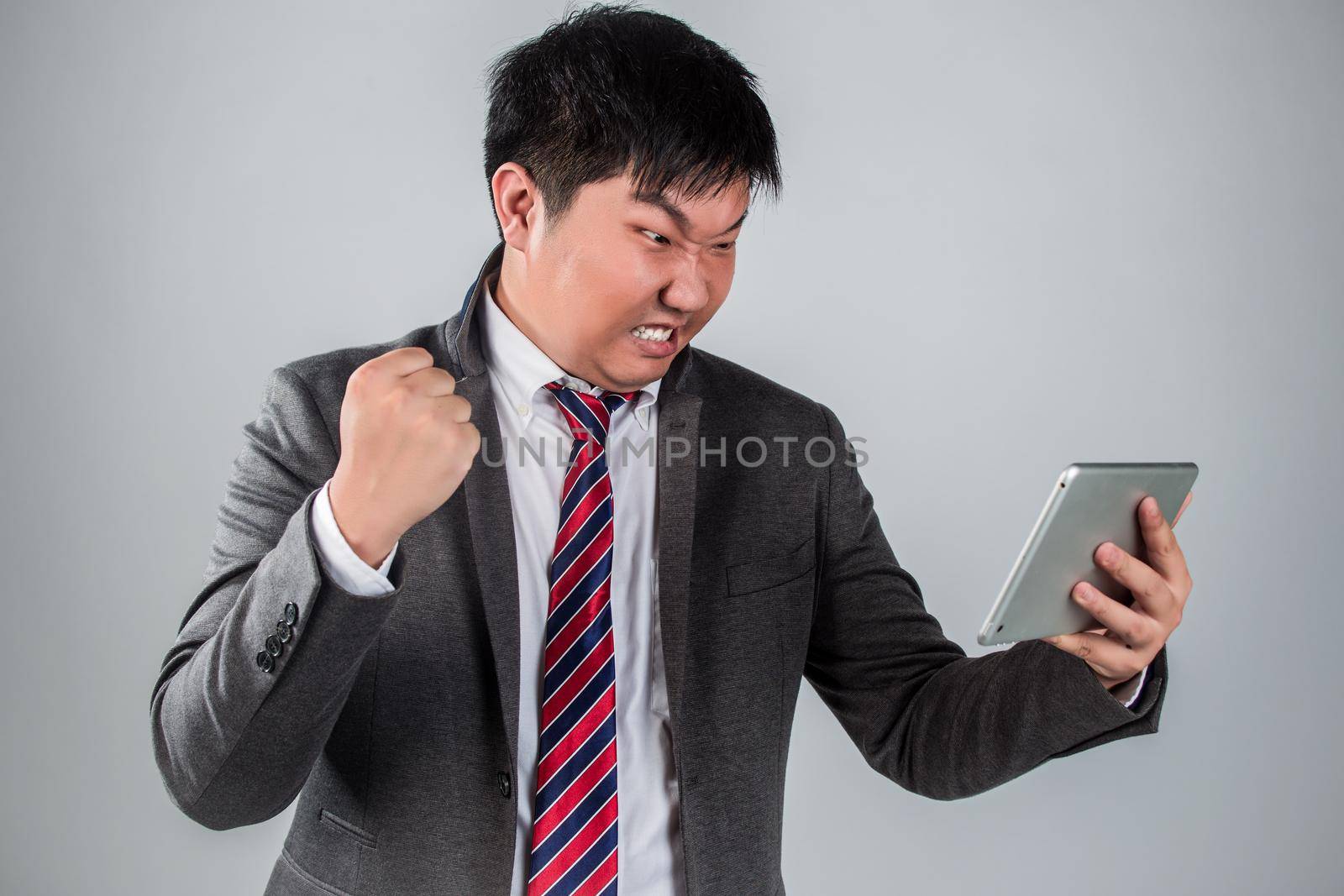 Mad man with digital tablet sitting on sofa by whatwolf