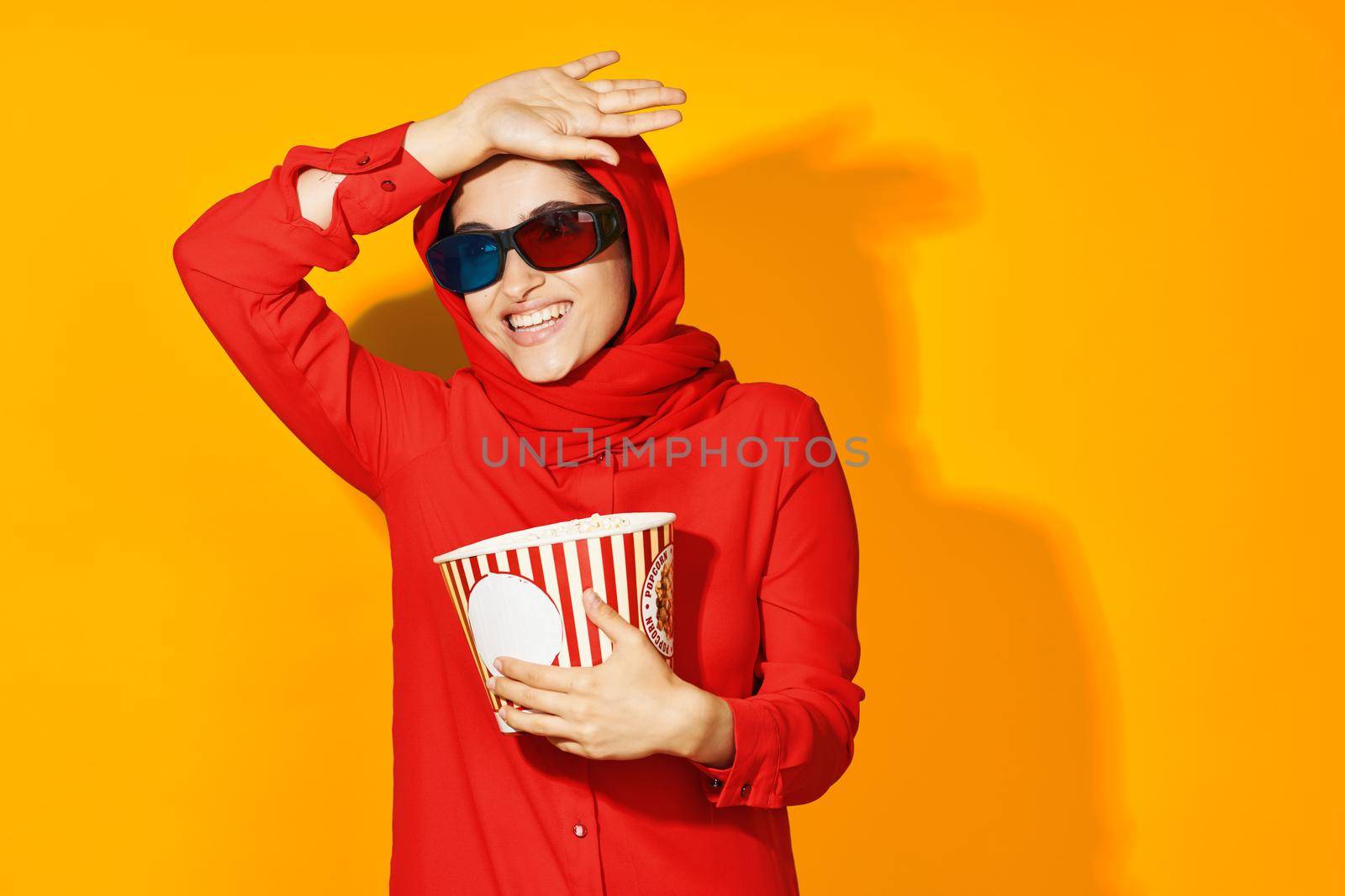 woman in red hijab popcorn entertainment cinema ethnicity model. High quality photo