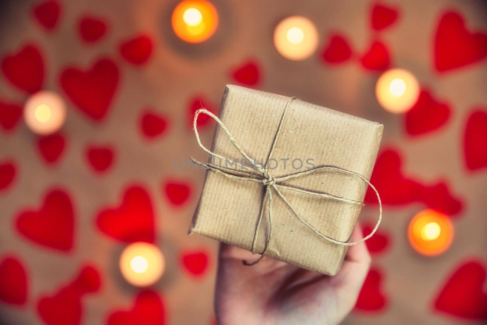 Hands holding beautiful gift box, female giving gift, Valentine's Day, holidays and greeting season concept, top view background romantic design