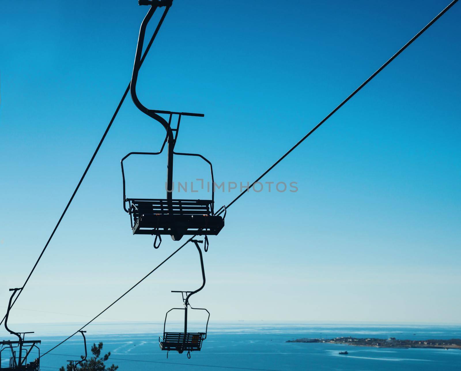 Cableway on background of blue sky, cableway funicular chair equipment, no people