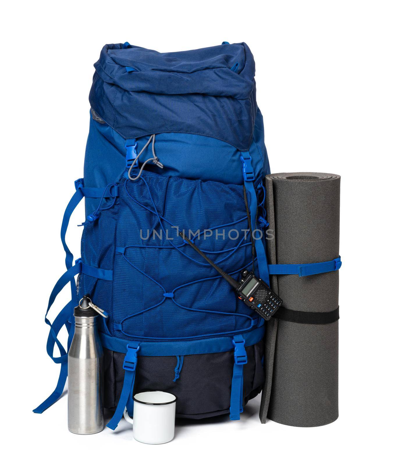 Blue hiking backpack with fitness mat isolated on white by Fabrikasimf