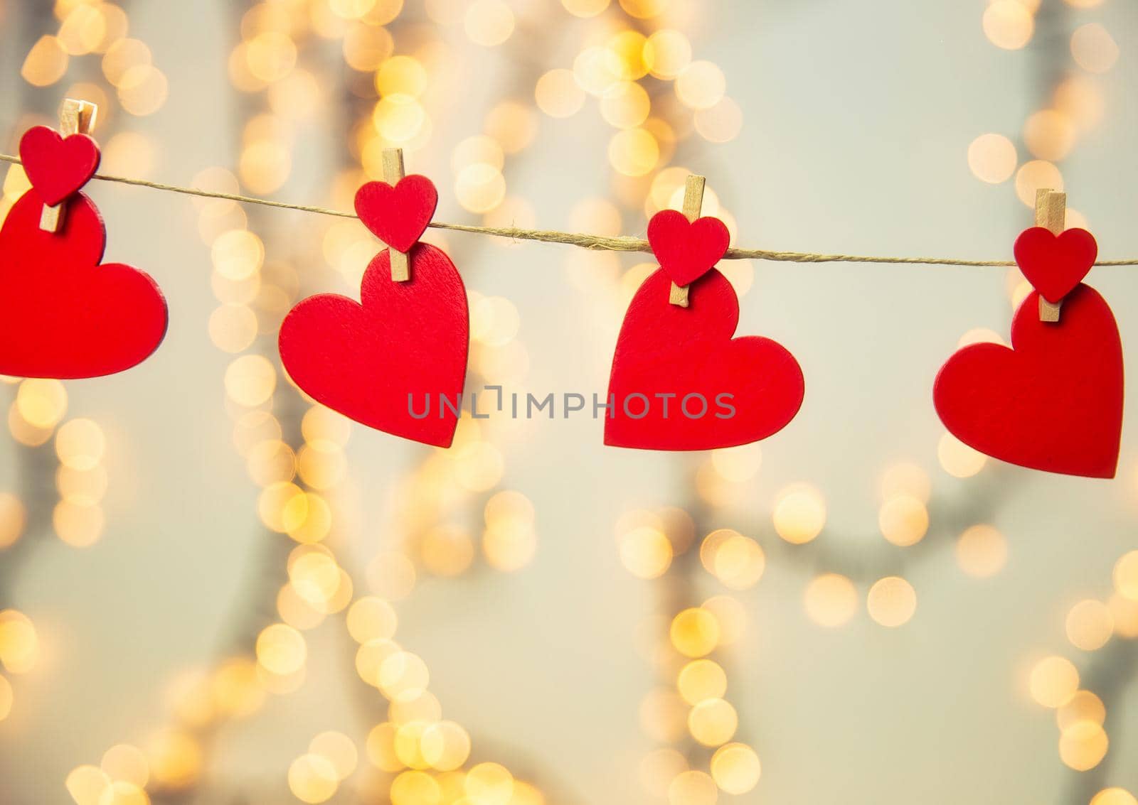 Happy Valentine day background with red hearts hang with clothespin on rope with bokeh background, romantic design, greeting card or copy space space for text