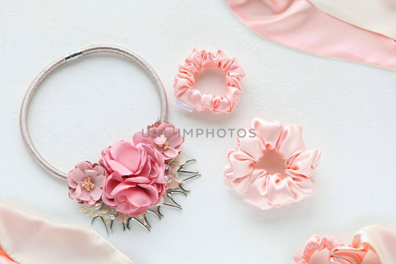 Pink hair accessories withroses. silk Pink Scrunchy isolated on white background. Flat lay Hairdressing tools and accessories as Color Hair Scrunchies, Elastic HairBands, Bobble Scrunchie Hairband