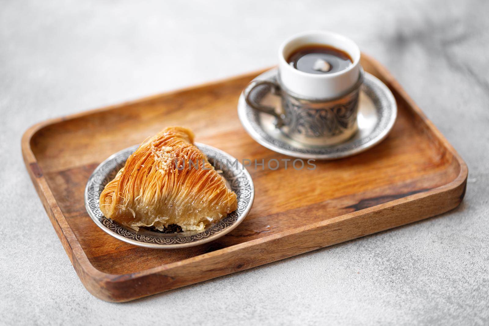 Small cup of Turkish coffee and Turkish baklava on table
