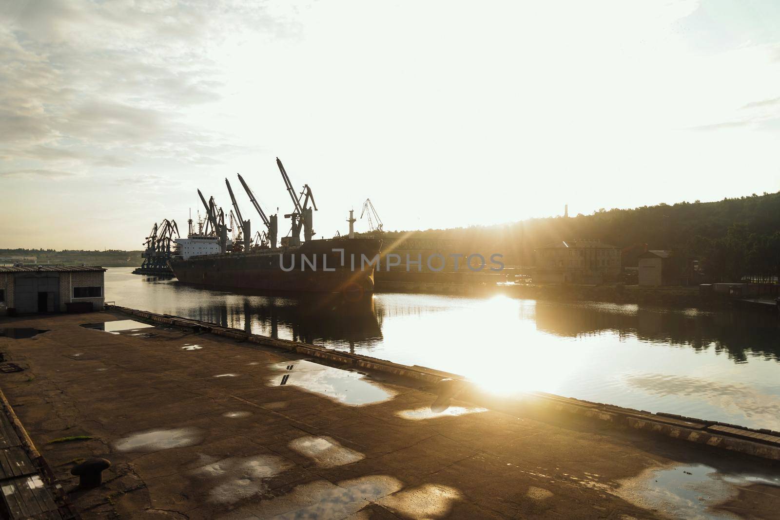 Seaport cargo ship in harbor, image with sunlight effect