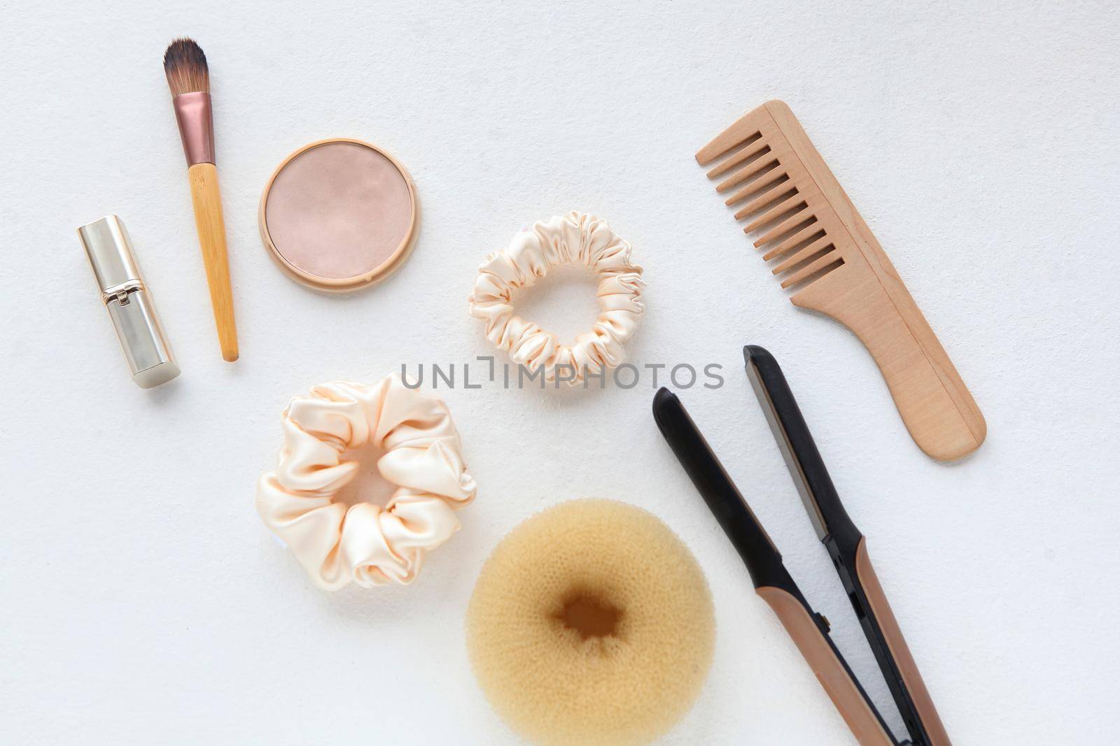 Lipstic, wooden Hairbrush, hair straightener, silk yellow Scrunchy isolated on white. Flat lay Hairdressing tools and accessories. Hair Scrunchies, Elastic HairBands, Bobble Sports Scrunchie Hairband